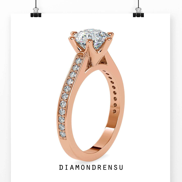 Channel set ring with a round brilliant cut diamond and a 6 prong engagement ring design.