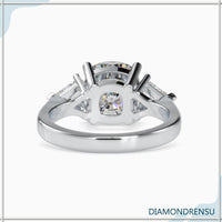 Kite cut three stone ring with cushion cut center diamond and side stones