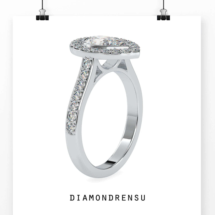 Teardrop diamond ring featuring an elegant pear shaped halo design.