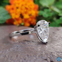 Pear shaped engagement ring set with exquisite precision and attention to detail.