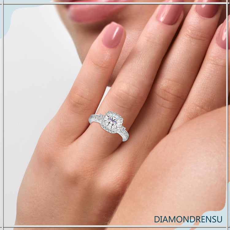 2 carat round cut diamond ring featuring an elegant three stone design.