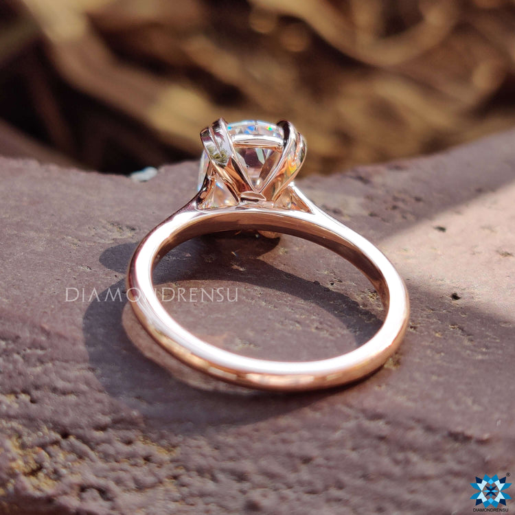 Moissanite solitaire engagement ring with a sparkling cushion cut stone.