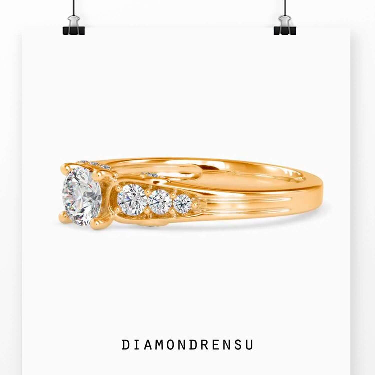 Diamond accent ring featuring a brilliant cut diamond and side stones.