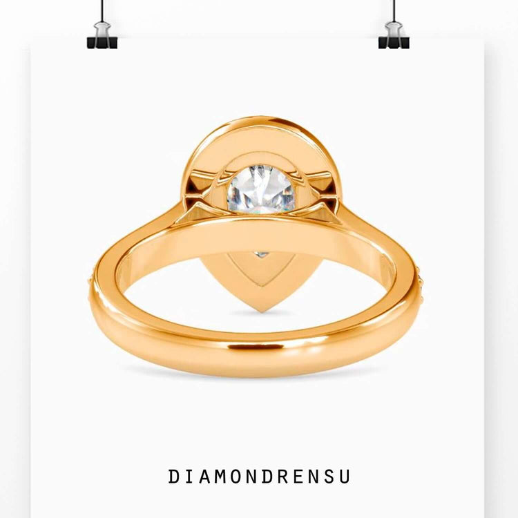 Handmade ring with a pear halo and pave ring diamond details.