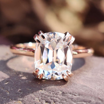 Cushion cut moissanite ring featuring a timeless cathedral setting design.