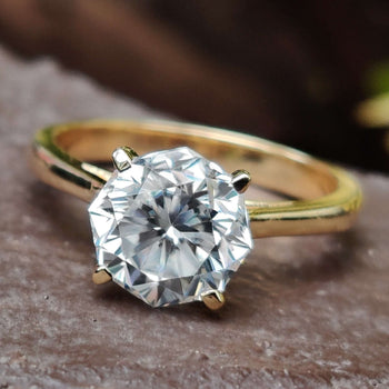 Simple gold solitaire ring featuring a timeless design for an elegant look.
