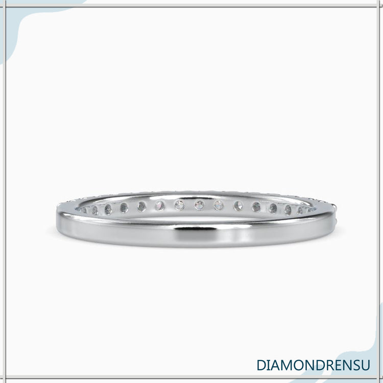 Simple gold prong setting diamond eternity band.