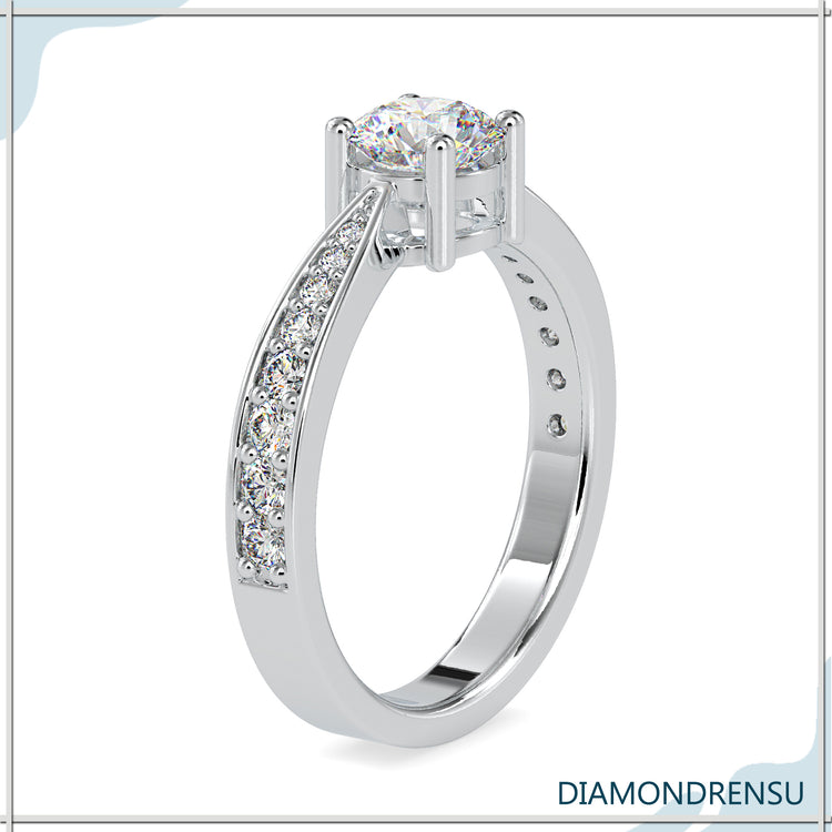Tapered shank engagement ring with a 2 carat round brilliant cut diamond in a 4 prong setting.