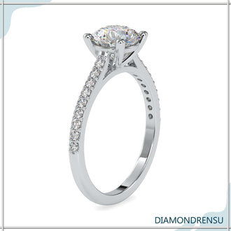 Pave engagement ring setting with a round diamond and a classic four prong ring style.