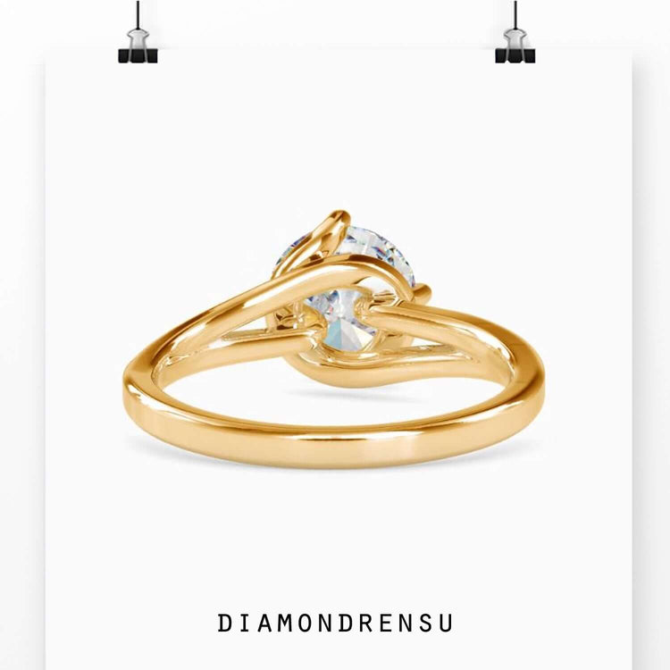 Solitaire and diamond ring featuring a bypass design in white gold.