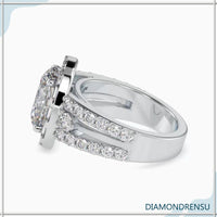 Oval halo ring with a 2 carat oval diamond and pave band.