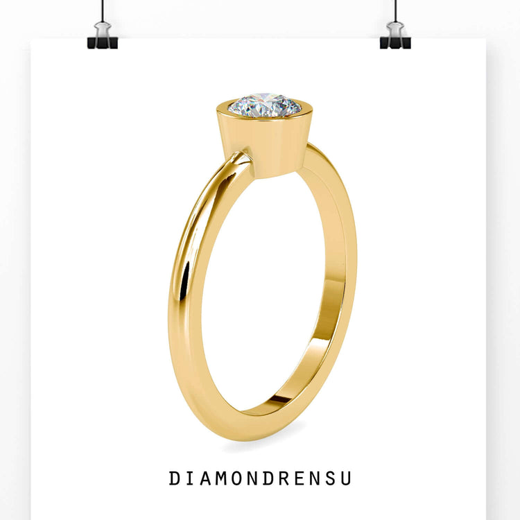 Classic solitaire engagement ring with a bezel set diamond for extra security.