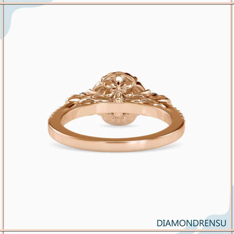 Halo engagement ring with a floral-inspired three stone design.