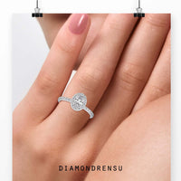 Oval halo engagement ring with a pave band and an IGI certified diamond for added brilliance.