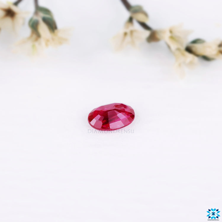 Oval cut gemstone categorized as 0.53 carat gemstone and ruby gemstone.
