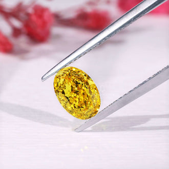 Loose lab grown yellow diamond with oval shape.