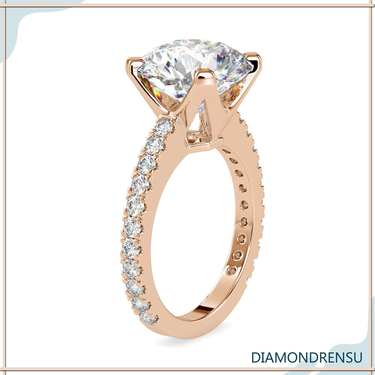 Pave ring setting featuring a round diamond engagement ring in white gold.