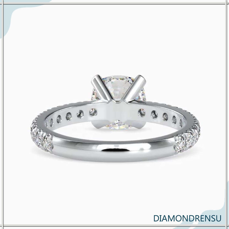 Pave engagement ring with a cushion cut diamond, available in rose, white, and yellow gold.