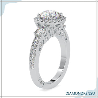 Three stone ring with a beautiful round brilliant cut diamond center.