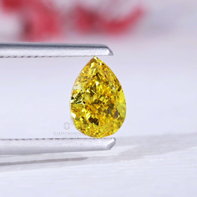 This pear cut diamond in yellow is IGI certified and lab grown.