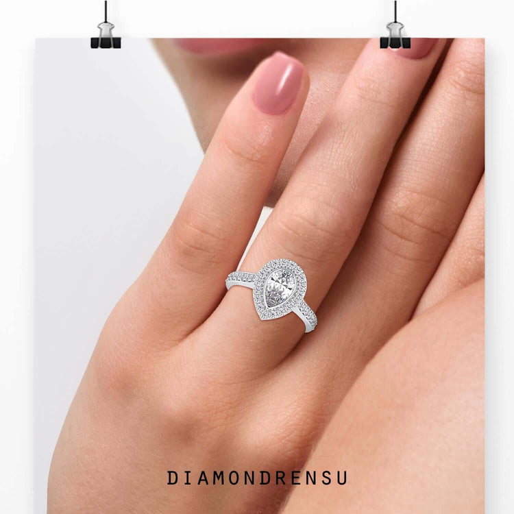 Pear cut engagement ring in a cathedral style with pave details.