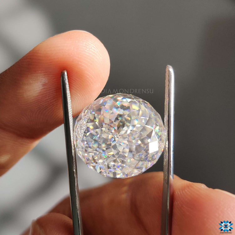 Loose moissanite stone sits beside moissanite loose stones.