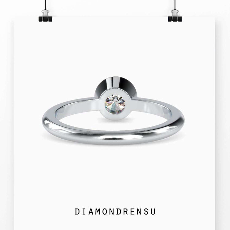 Modern round bezel set engagement ring in white gold for a sleek and elegant style.