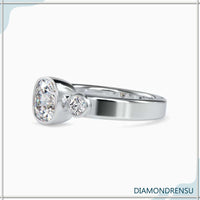 Three stone diamond engagement ring with a cushion cut center stone and IGI certified diamonds.