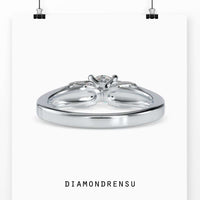 Round diamond accent ring with a four prong engagement setting.