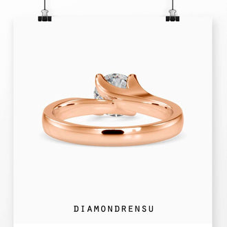 Four prong ring setting featuring a bypass solitaire engagement style.