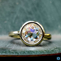 Round bezel ring perfect for engagements or everyday wear.