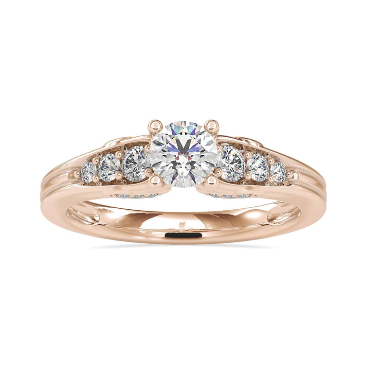 Four prong diamond ring with side stones and brilliant cut diamond.