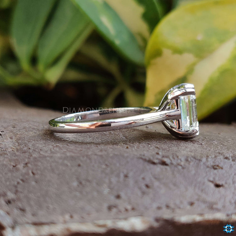 Unique emerald cut cathedral setting with intricate details.