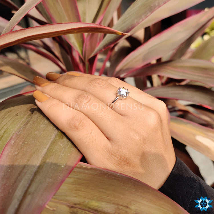 Sophisticated moissanite solitaire engagement ring in minimalist style.