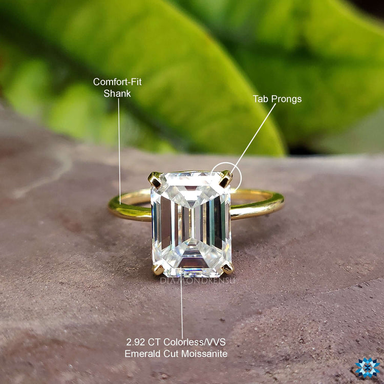 Stunning moissanite solitaire engagement ring that highlights the beauty of the emerald cut.