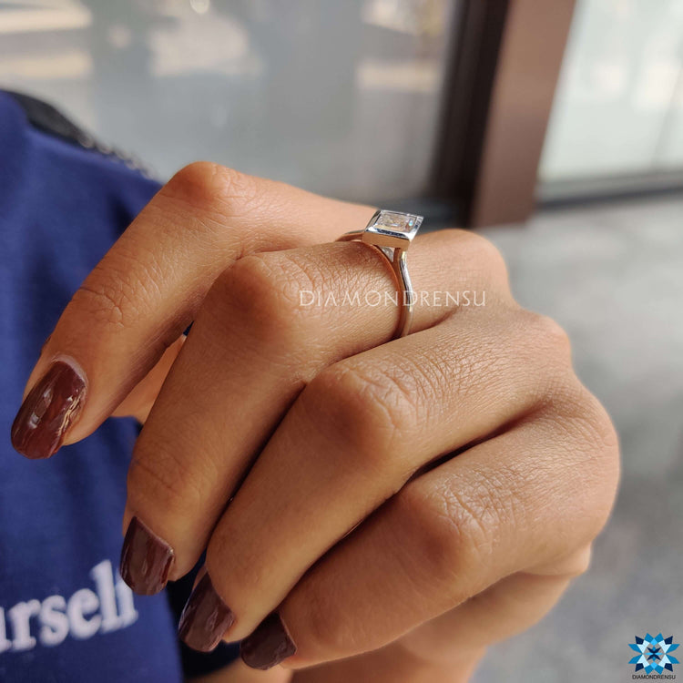 White gold bezel ring with a minimalist design.
