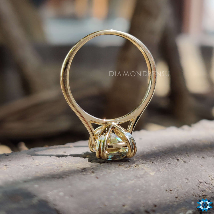 A radiant elongated cushion moissanite ring featuring a claw prong setting.