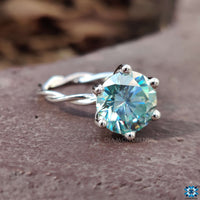 Moissanite twist engagement ring in a modern prong setting.