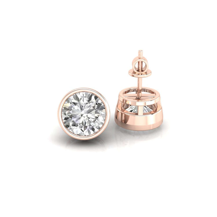 Classic diamond earrings round, set in a handmade bezel earring design for extra shine.