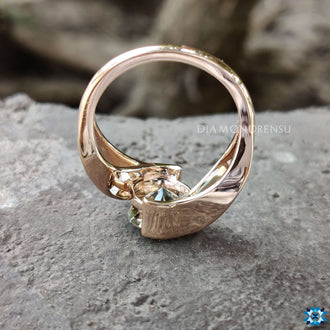 Unique round moissanite ring set in a polished gold band.