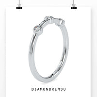 Round diamond wedding band in yellow gold with a bezel setting