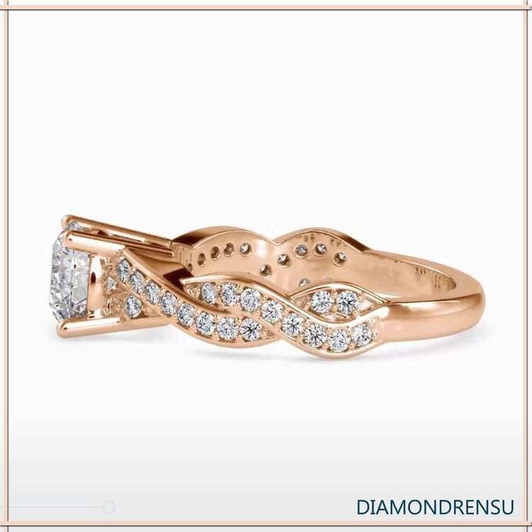 Stunning twisted gold ring featuring a lab grown diamond in a basket setting.