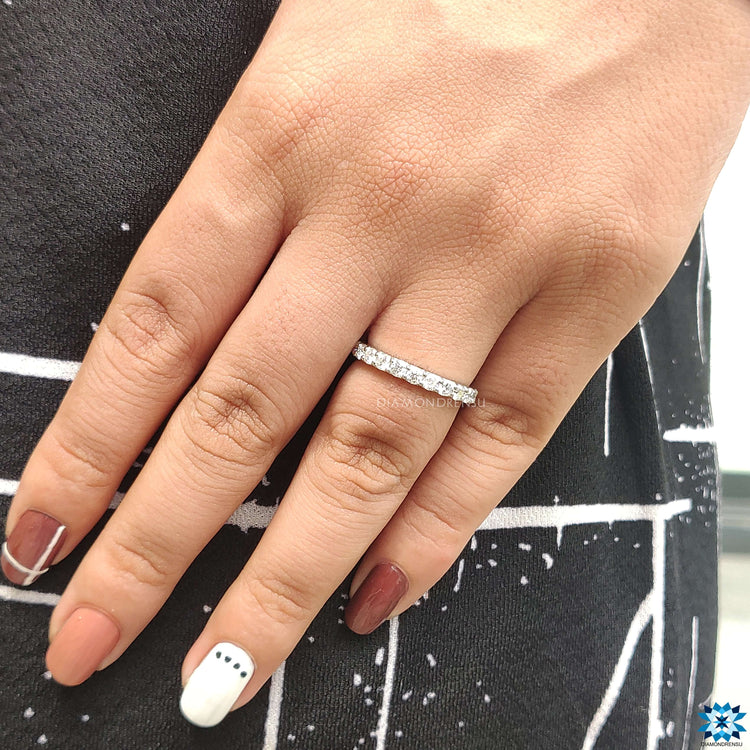 Round prong set wedding band with sparkling accents.