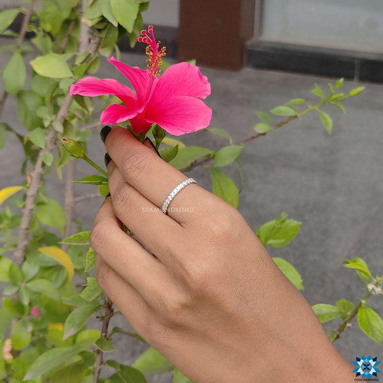 Shared prong eternity band with sparkling moissanite stones.