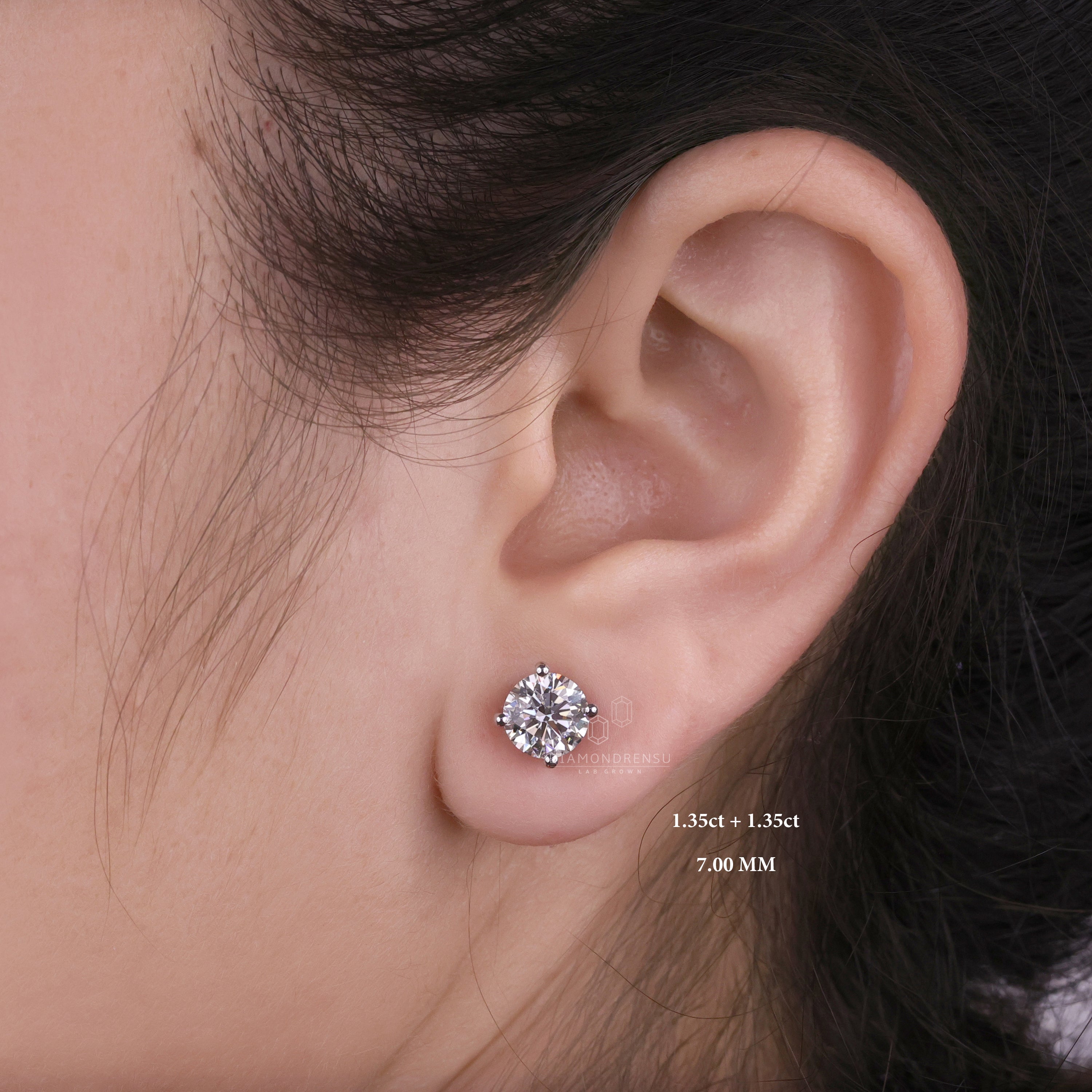 Model displaying gold and diamond stud earrings, focusing on their intricate design and lustrous appeal