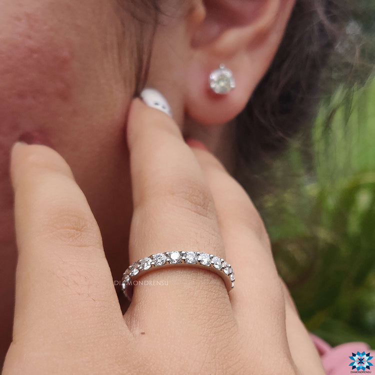 Prong setting wedding band featuring stunning round stones.