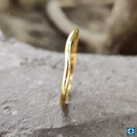 Plain curved wedding band in yellow gold for a simple, elegant touch.