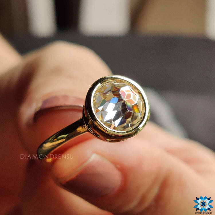 Round bezel engagement ring with a sparkling moissanite centrepiece.