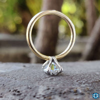A modern claw prong engagement ring with a sparkling diamond centrepiece.