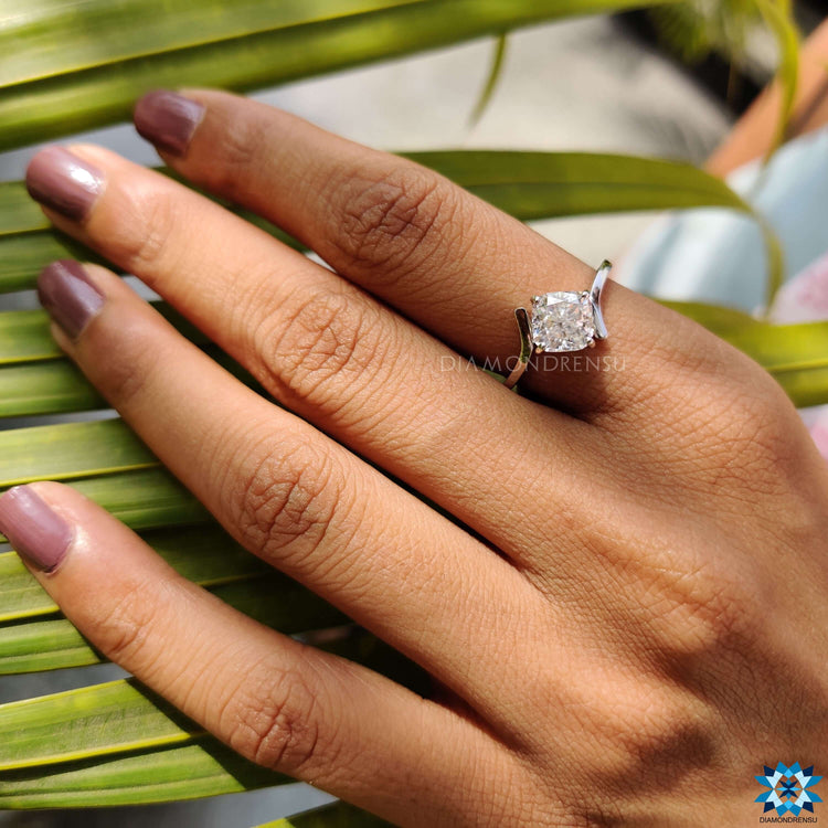A 4 prong diamond ring shimmering under soft light, exuding luxurious simplicity.